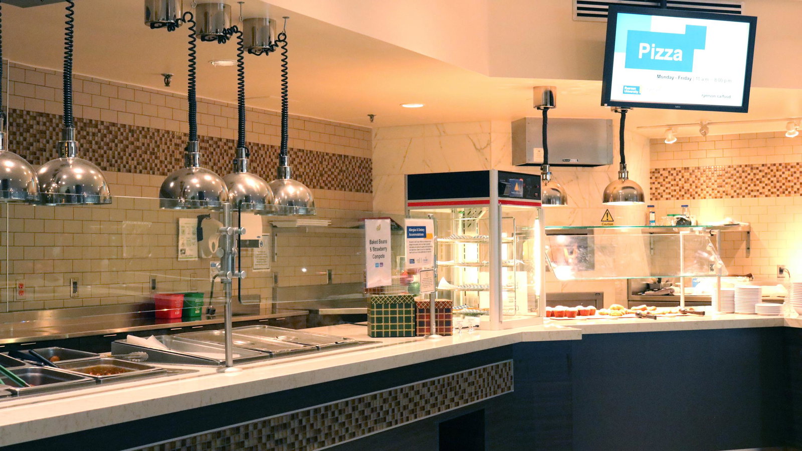Dietary Accommodations features multiple polished silver food warming lamps above the serving line.