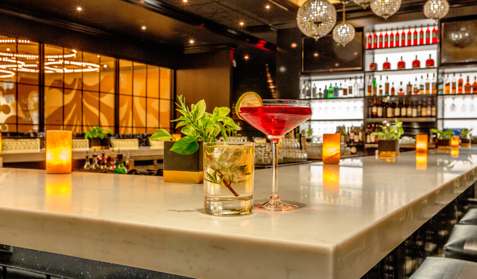 Bar Design and Setting features a sleek white marble bar counter.