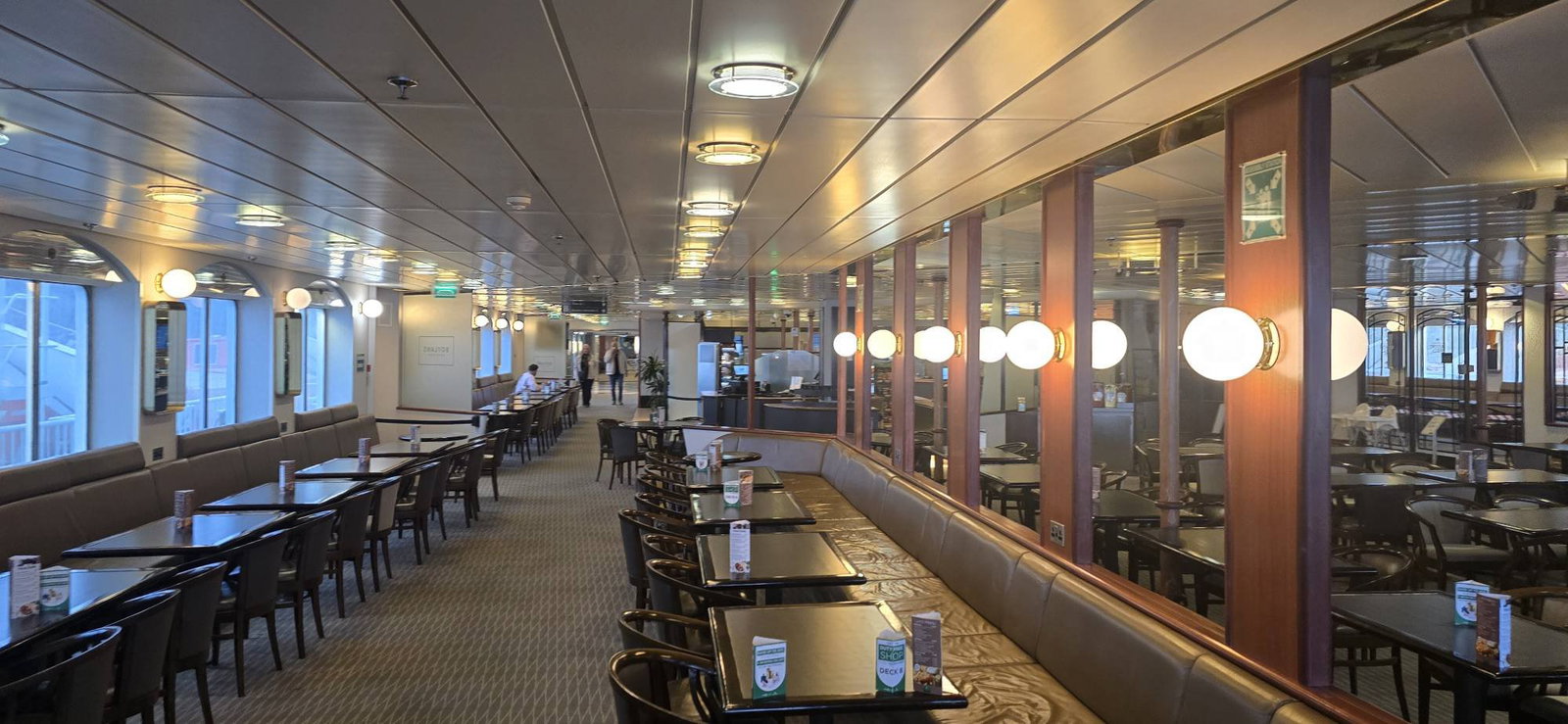 4. Champagne Week, France, features a long interior brightly lit by a series of warm, round wall lights.