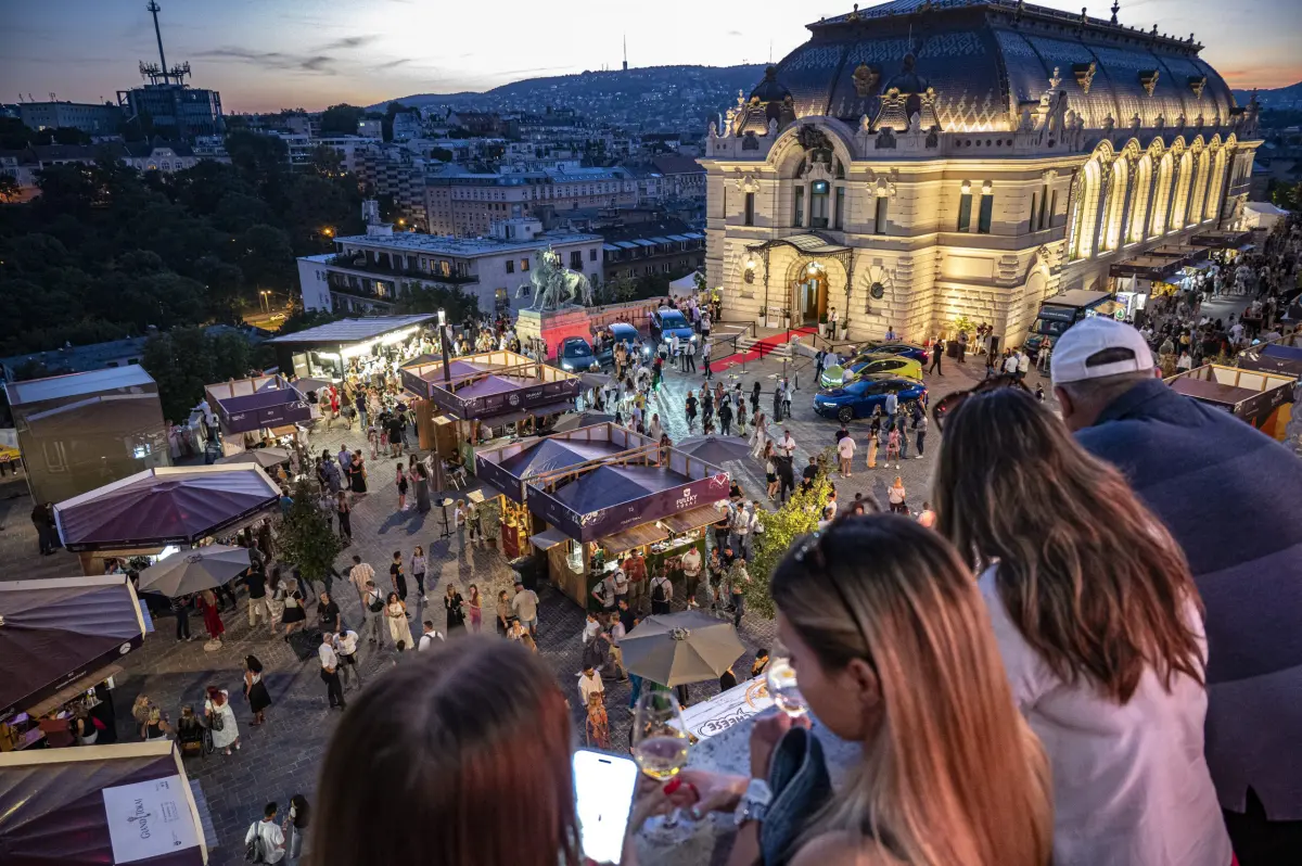 6. Budapest Wine Festival, Hungary features a grand, brightly lit building overlooking the lively crowd.