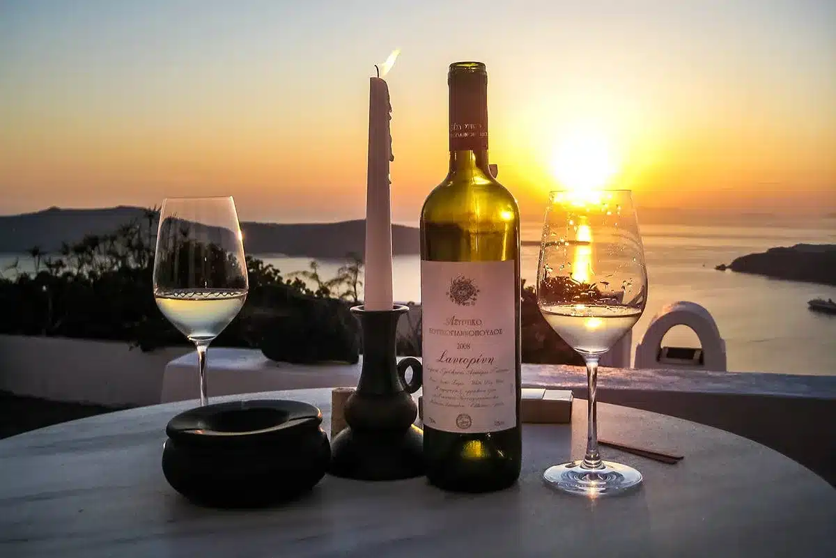 8. Santorini Wine Festival, Greece, highlights the dramatic orange glow of the sunset over the water.