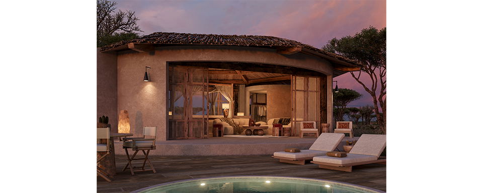 Evening view of a safari lodge villa with a curved plunge pool, wooden sun loungers, and an open-air pavilion with warm interior lighting against a purple twilight sky.