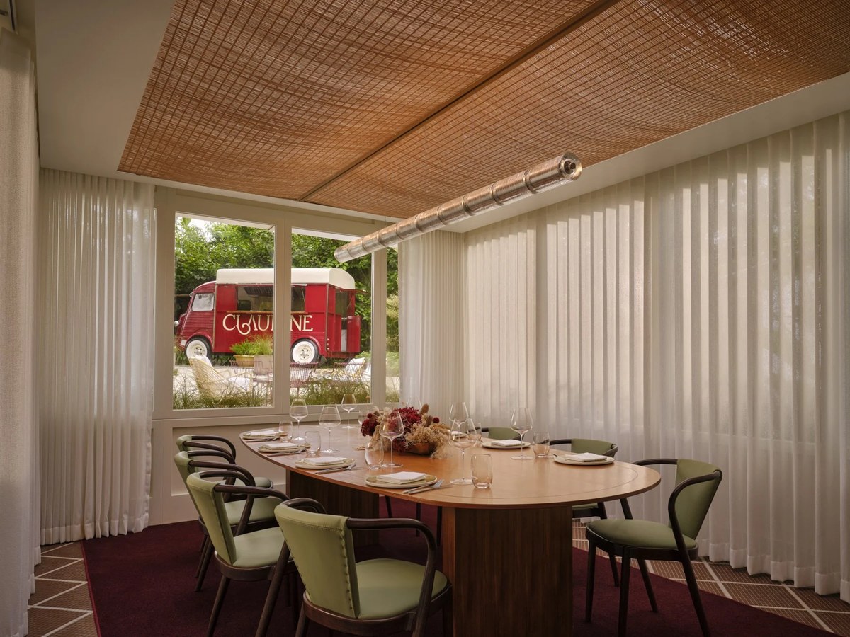 Claudine restaurant Singapore interior: An elegant private dining room with a view of a vintage red van.