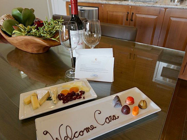 Welcome treats: wine, cheese, chocolates, and a note.