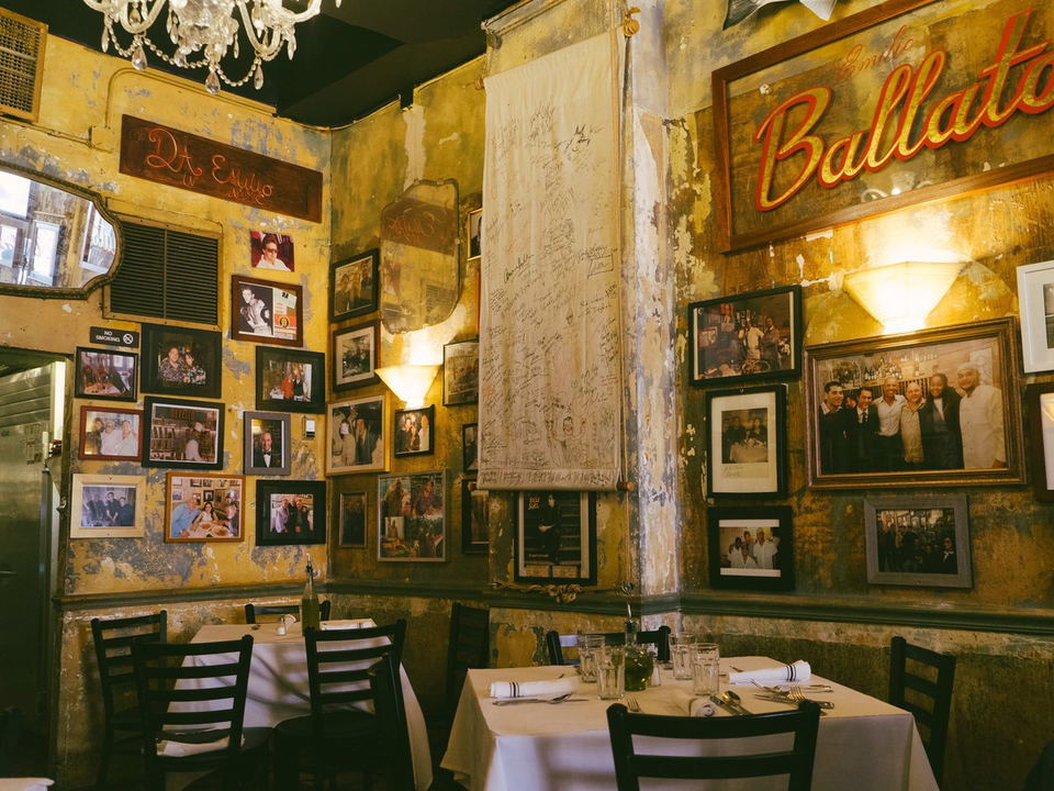 Cozy, historic New York City restaurant with framed photos and chandeliers