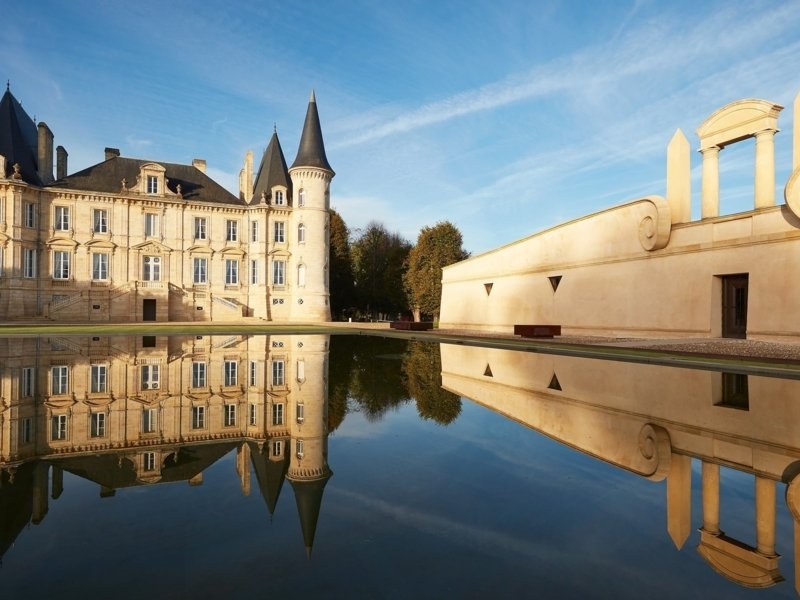 Château Mouton Rothschild and its reflecting pool under a blue sky