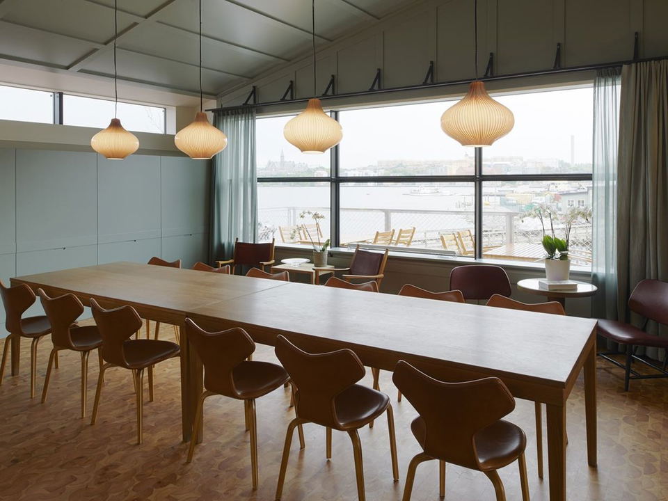 Long wooden table with chairs in a bright room