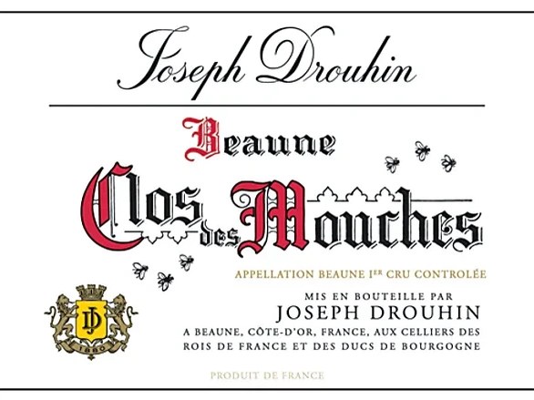 A white wine label for Joseph Drouhin Beaune Clos des Mouches Appellation Beaune 1er Cru Contrôlée, featuring elegant red and black script.