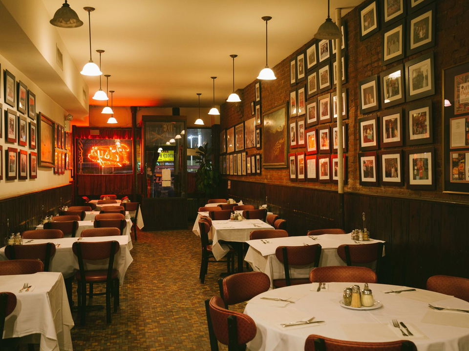 A Midtown dining room, an accessible old-school Italian alternative, with white tablecloths and framed photos.