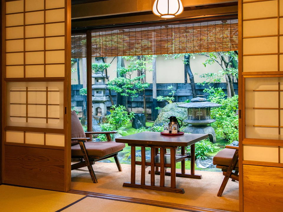 A traditional Japanese room with a view of a serene garden.