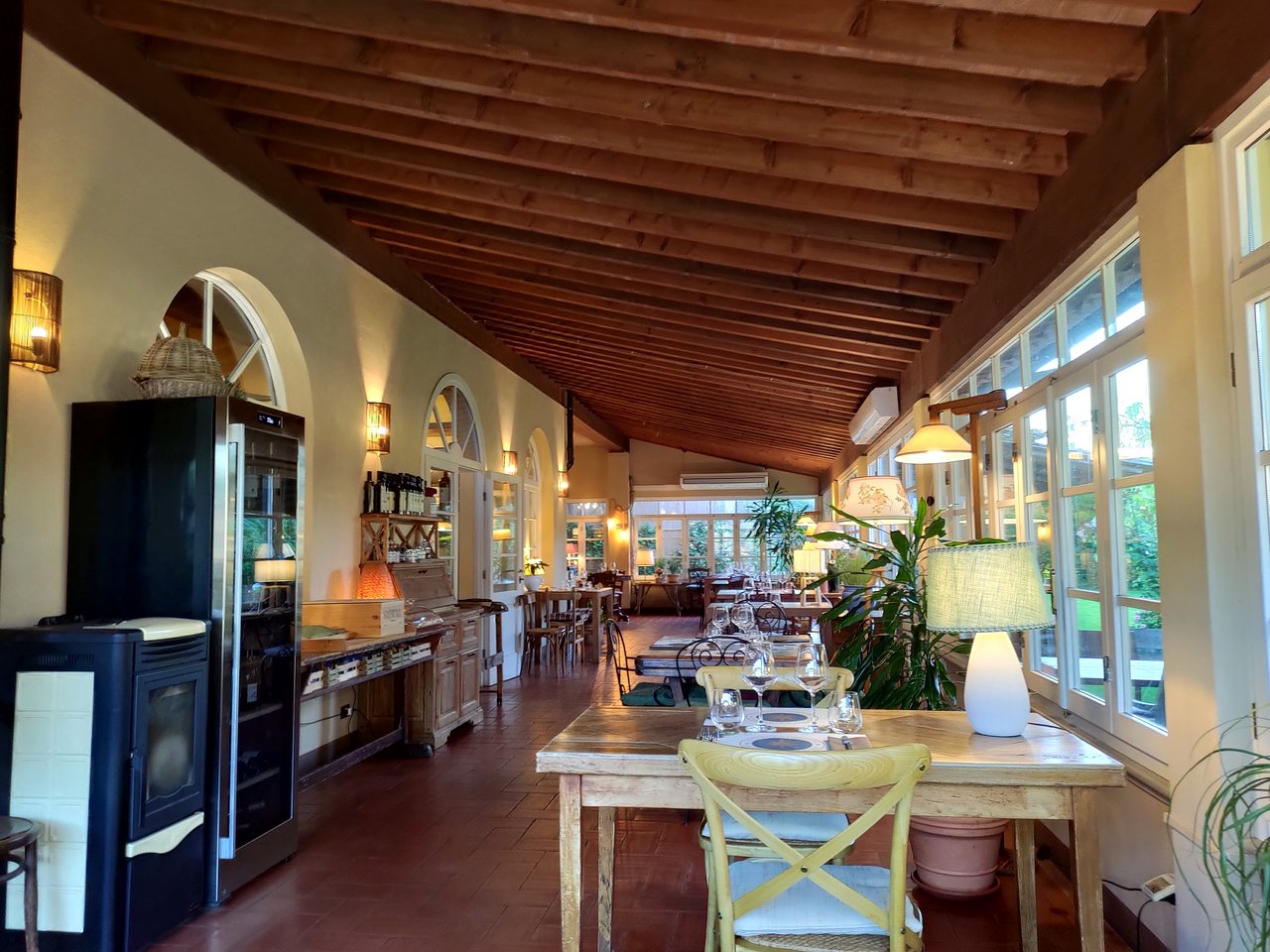 The Public Alternative: Osteria Enoteca San Guido features a warm interior with a distinctive wooden beamed ceiling.