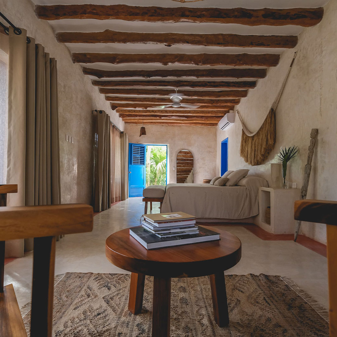 The Top Selling Points of Wakax Hacienda feature a vibrant blue door opening to lush greenery.