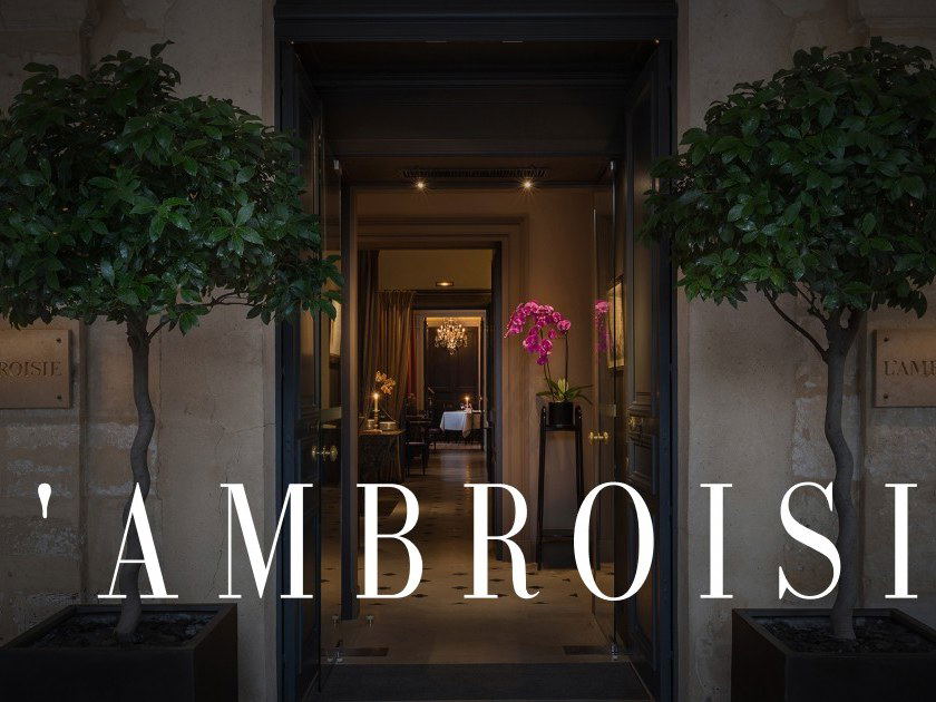 Entrance to L'Ambroisie with potted plants and a glimpse of the dining area.