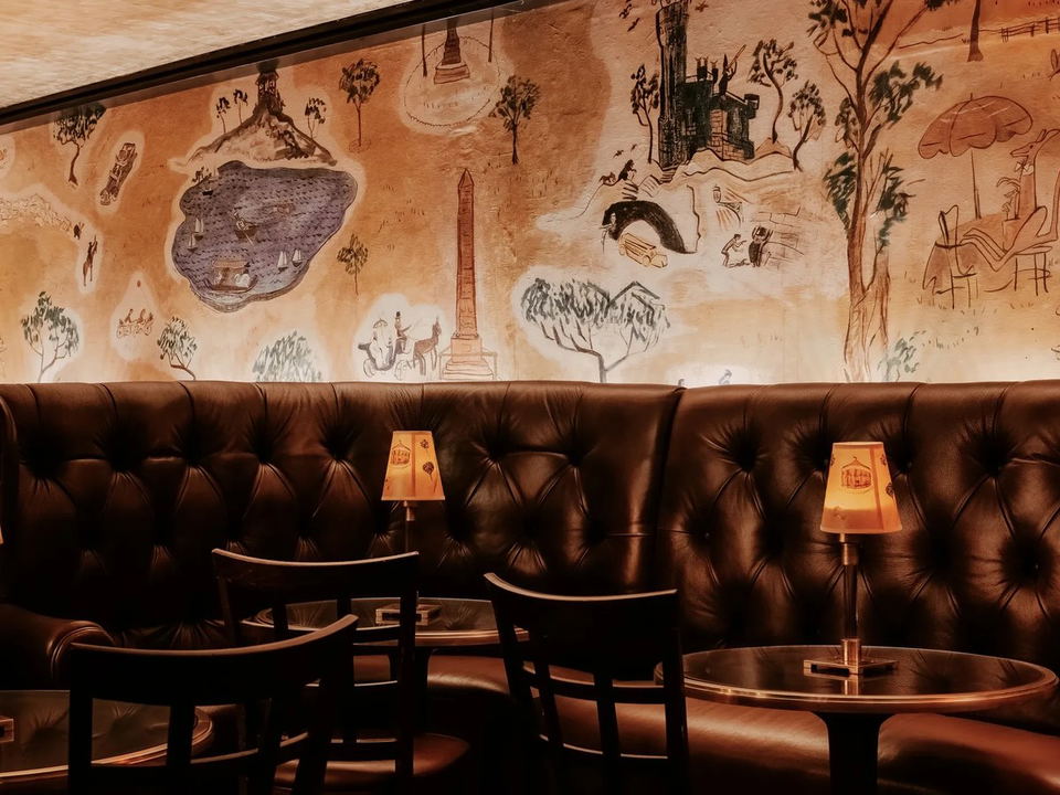 The Carlyle hotel bar's hand-painted murals and tufted leather banquettes offer a storied Manhattan alternative.