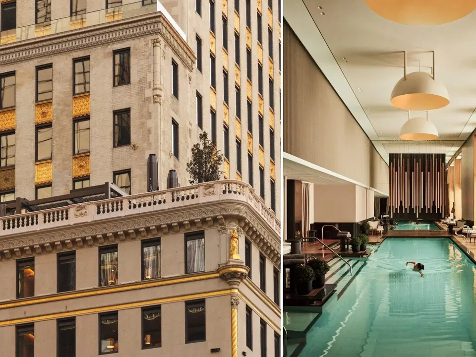 Interior view of a luxury hotel swimming pool with turquoise water, modern ceiling lights, and large windows showing historic buildings outside.