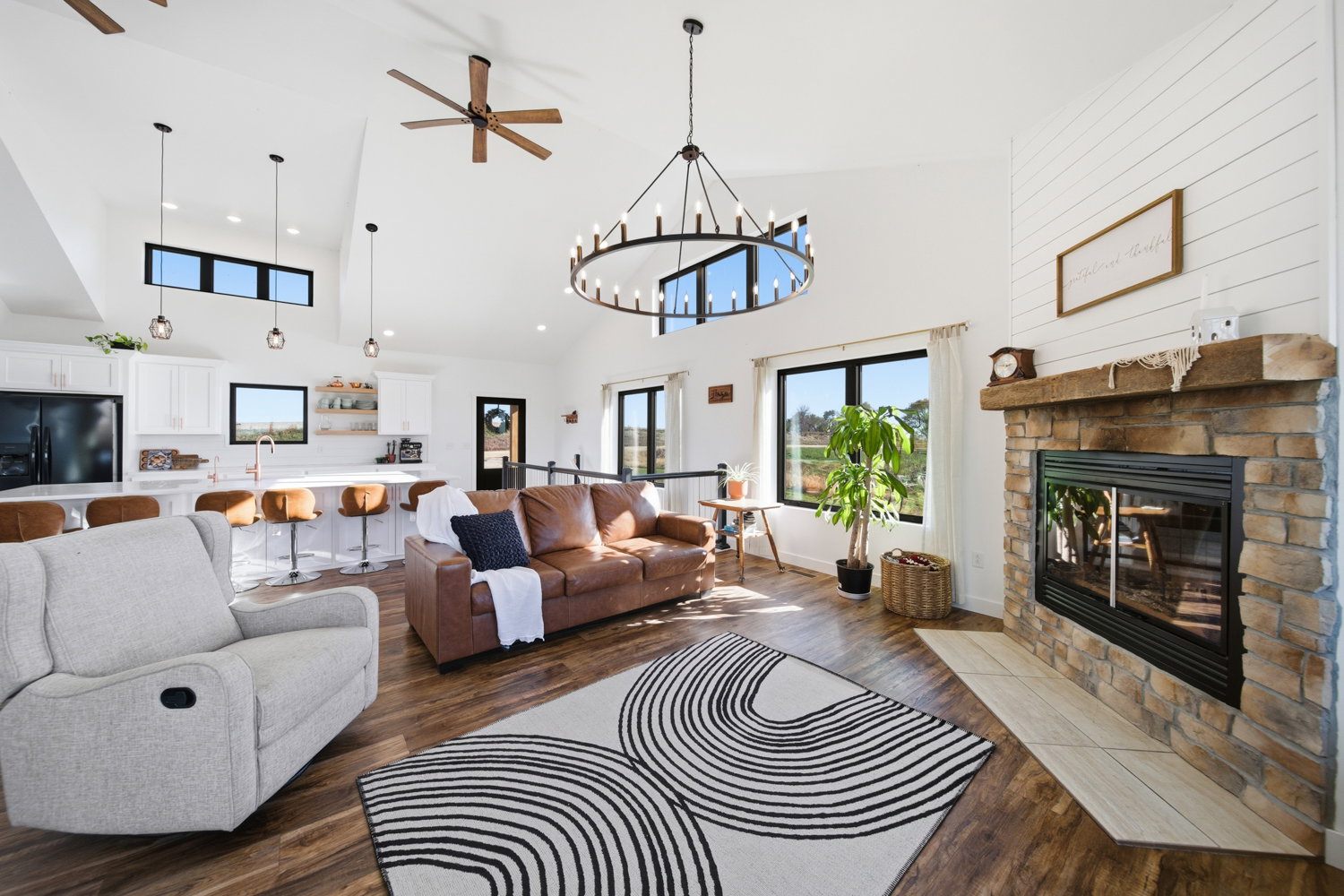 Property Features and Local Activities features a striking stone fireplace with a rustic wooden mantel.