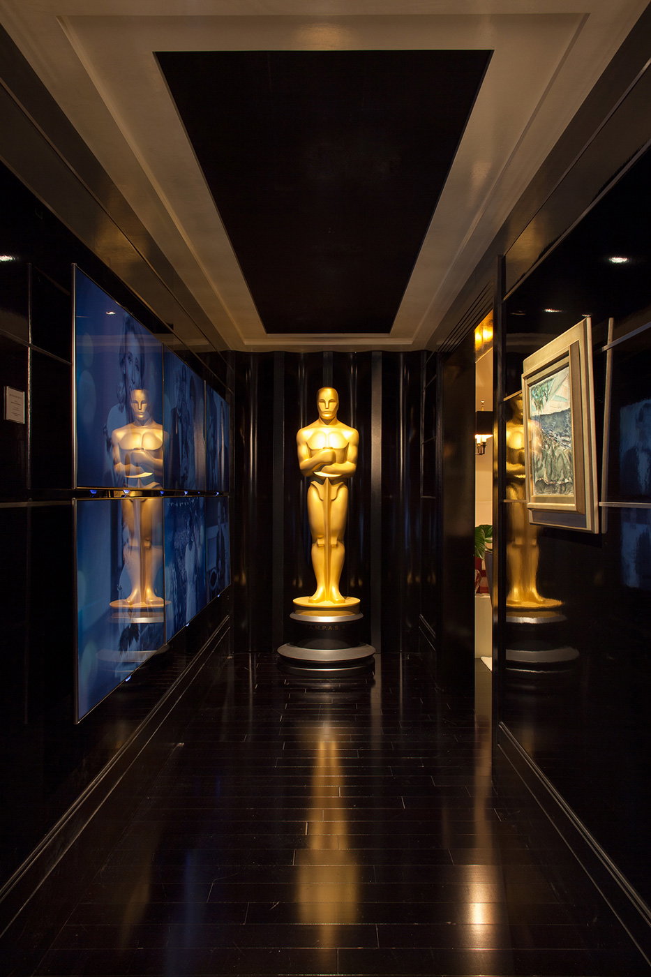 Awards and Special Features, featuring a prominent golden statue illuminated in the dark hallway.