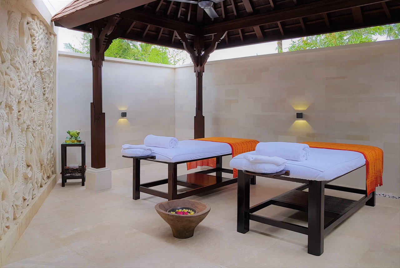 Room Features and Spa Services features an ornate carved stone wall.