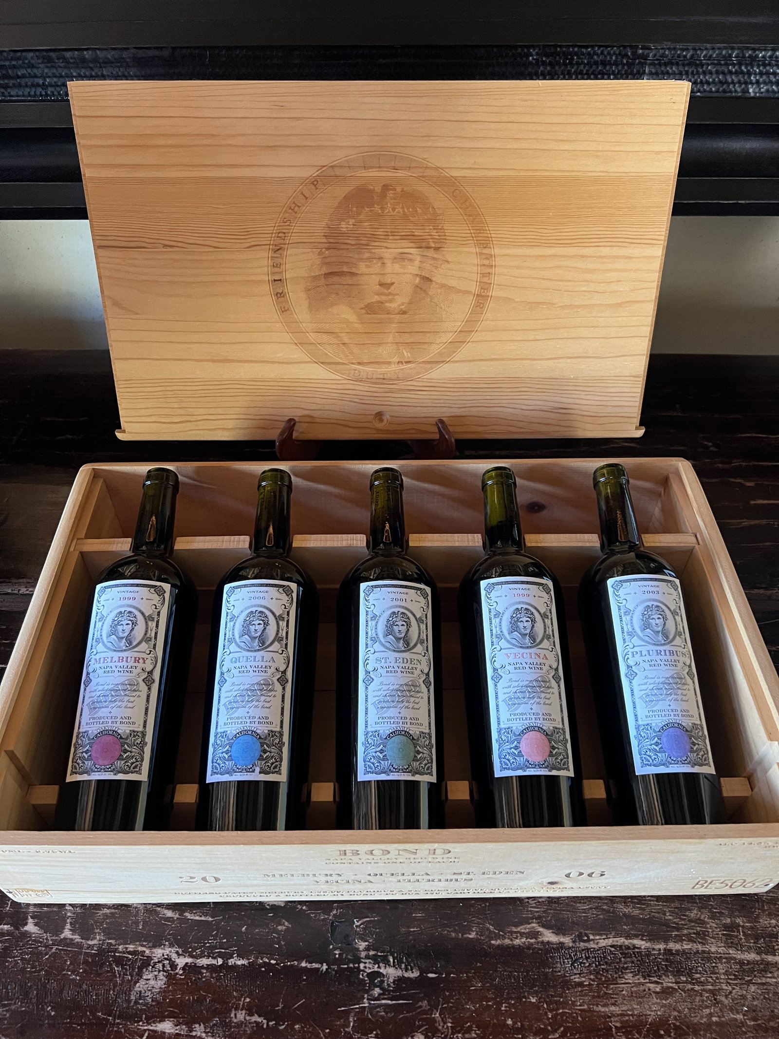 Five bottles of wine in a wooden box