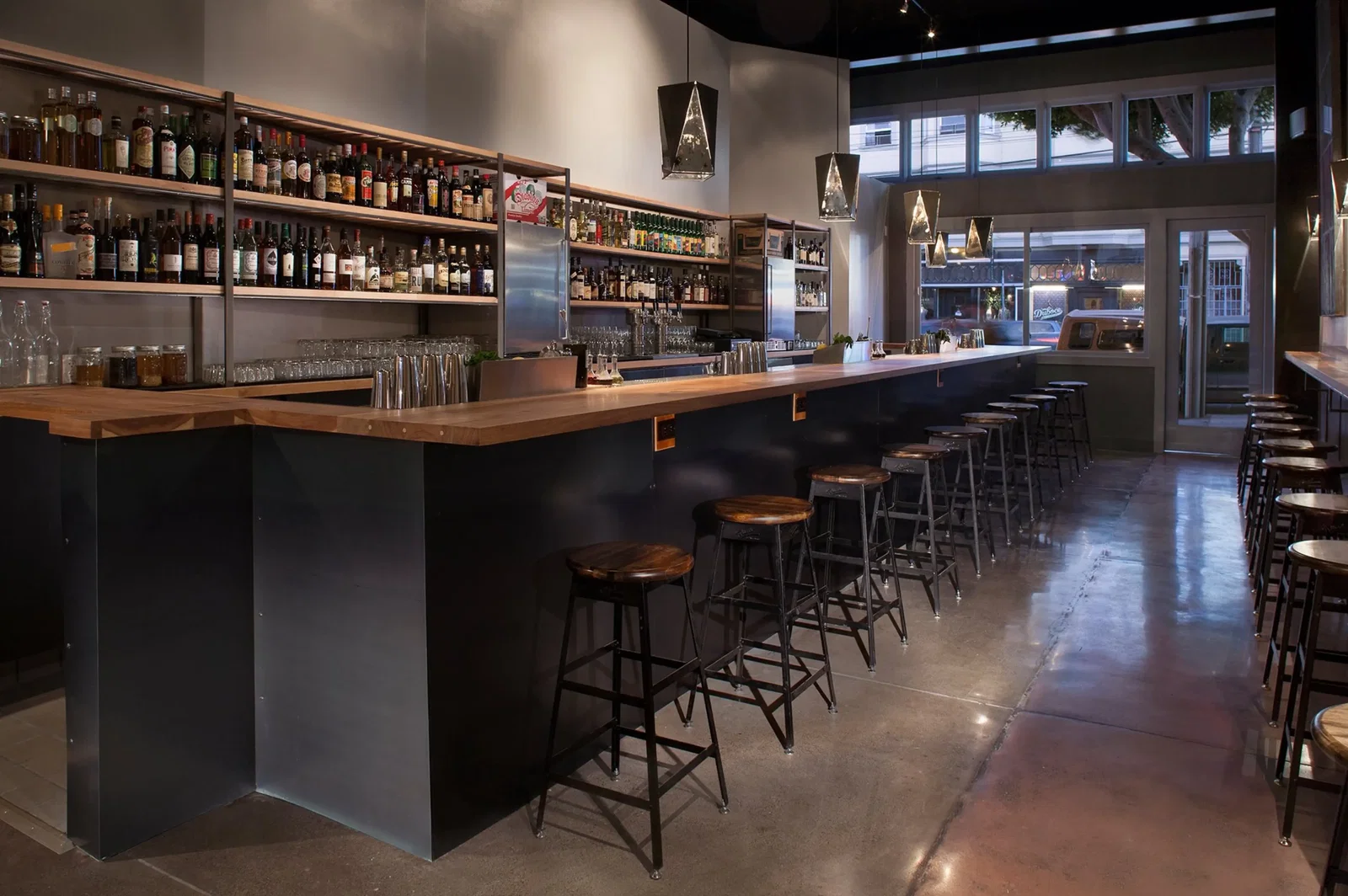 the inside of a bar with stools