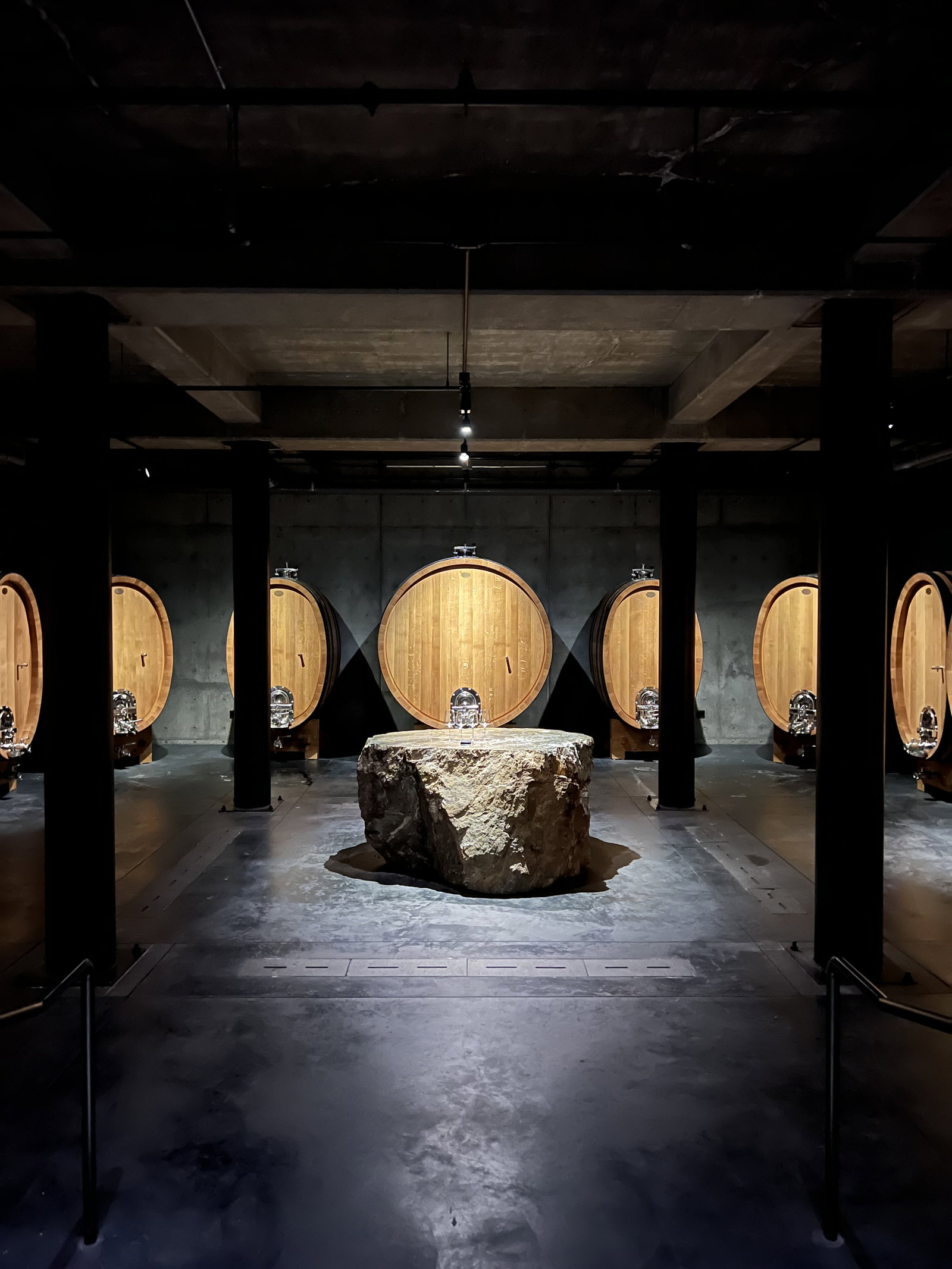 inside of a wine cellar with a big rock in the middle