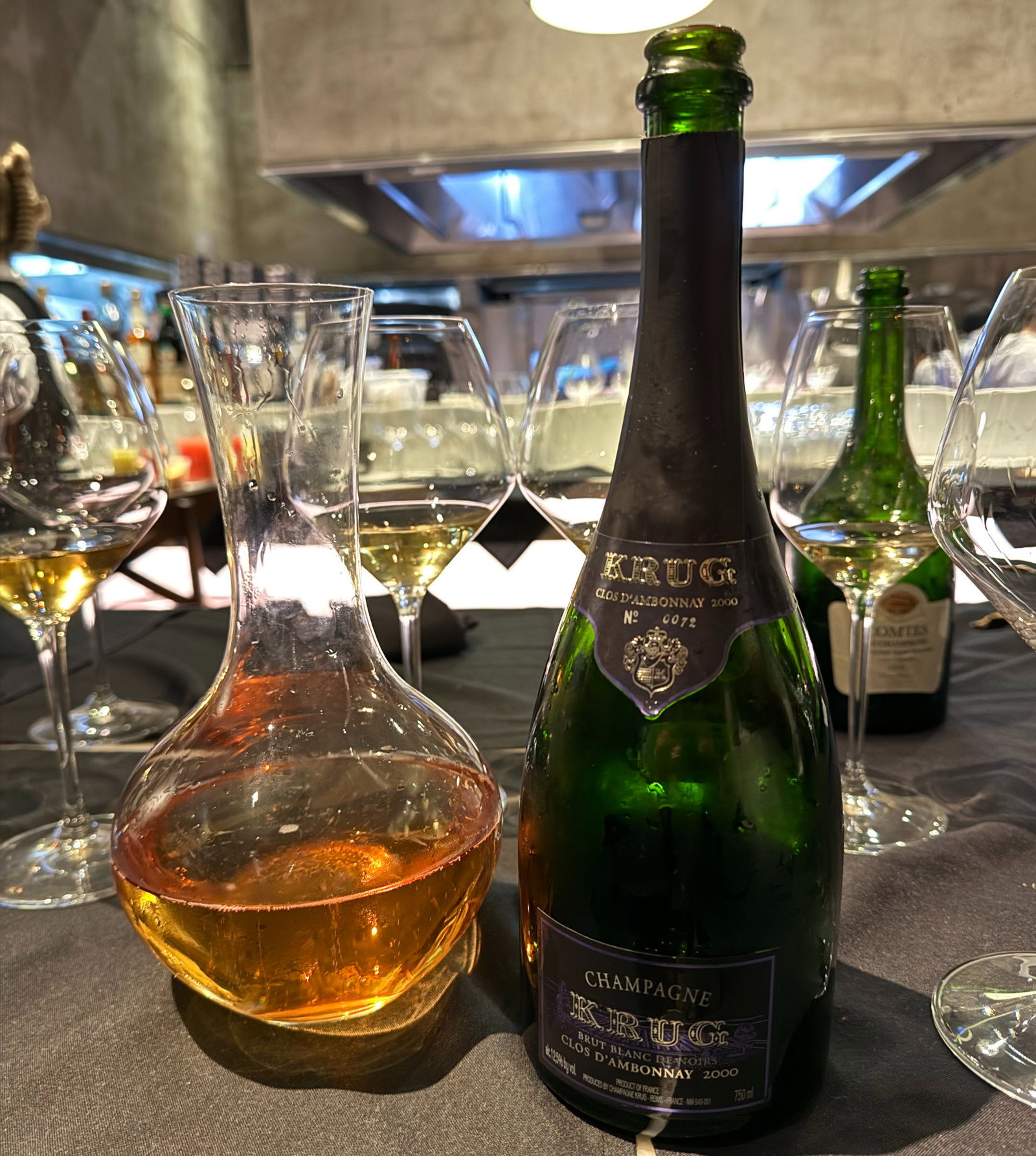 a bottle of champagne next to a decanter