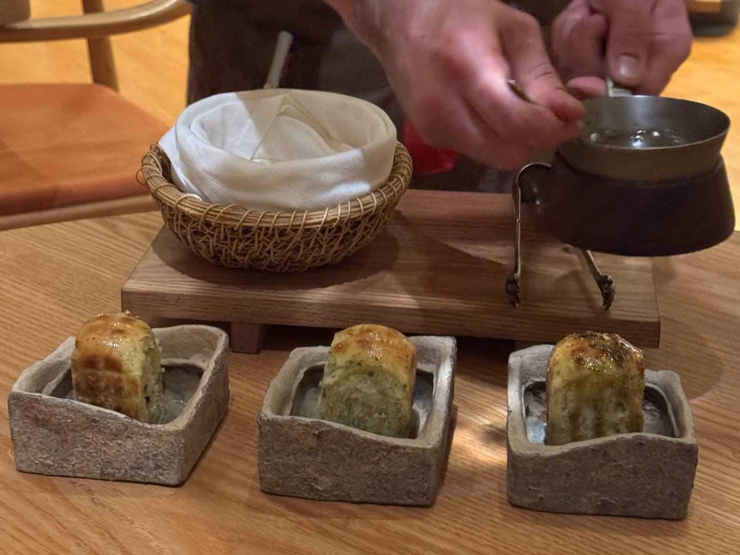 Ember Roasted Black Cod with sunflower seed milk, sea lettuce Parker House roll, and smoked fish and kelp