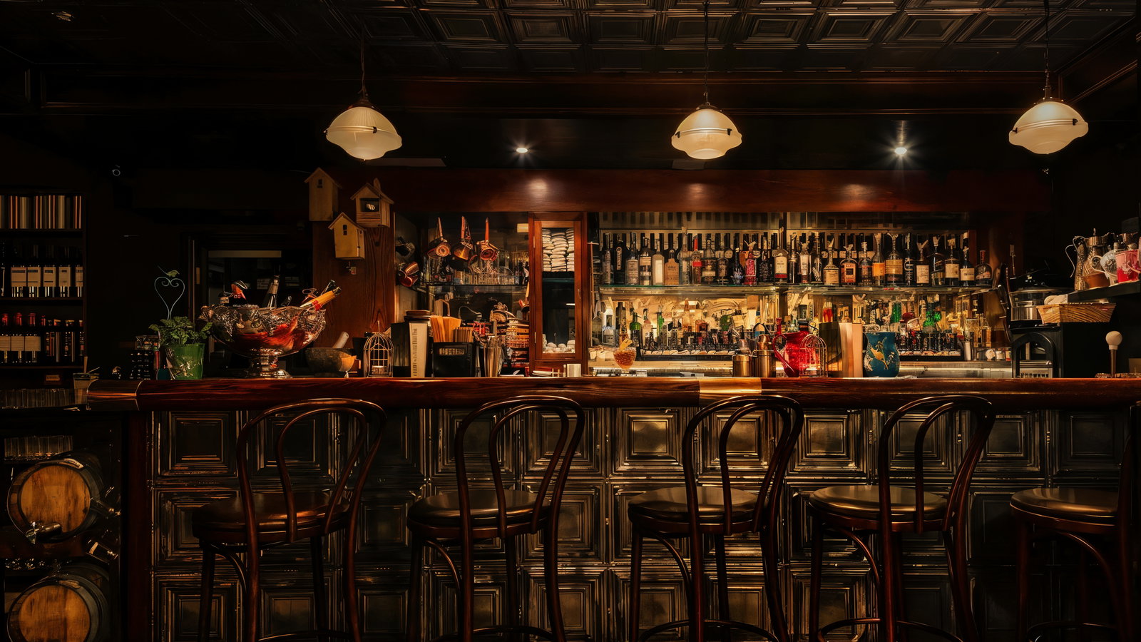 Dimly lit bar interior with wooden stools, bottles on shelves, hanging lights, and warm tones creating a cozy, inviting atmosphere.