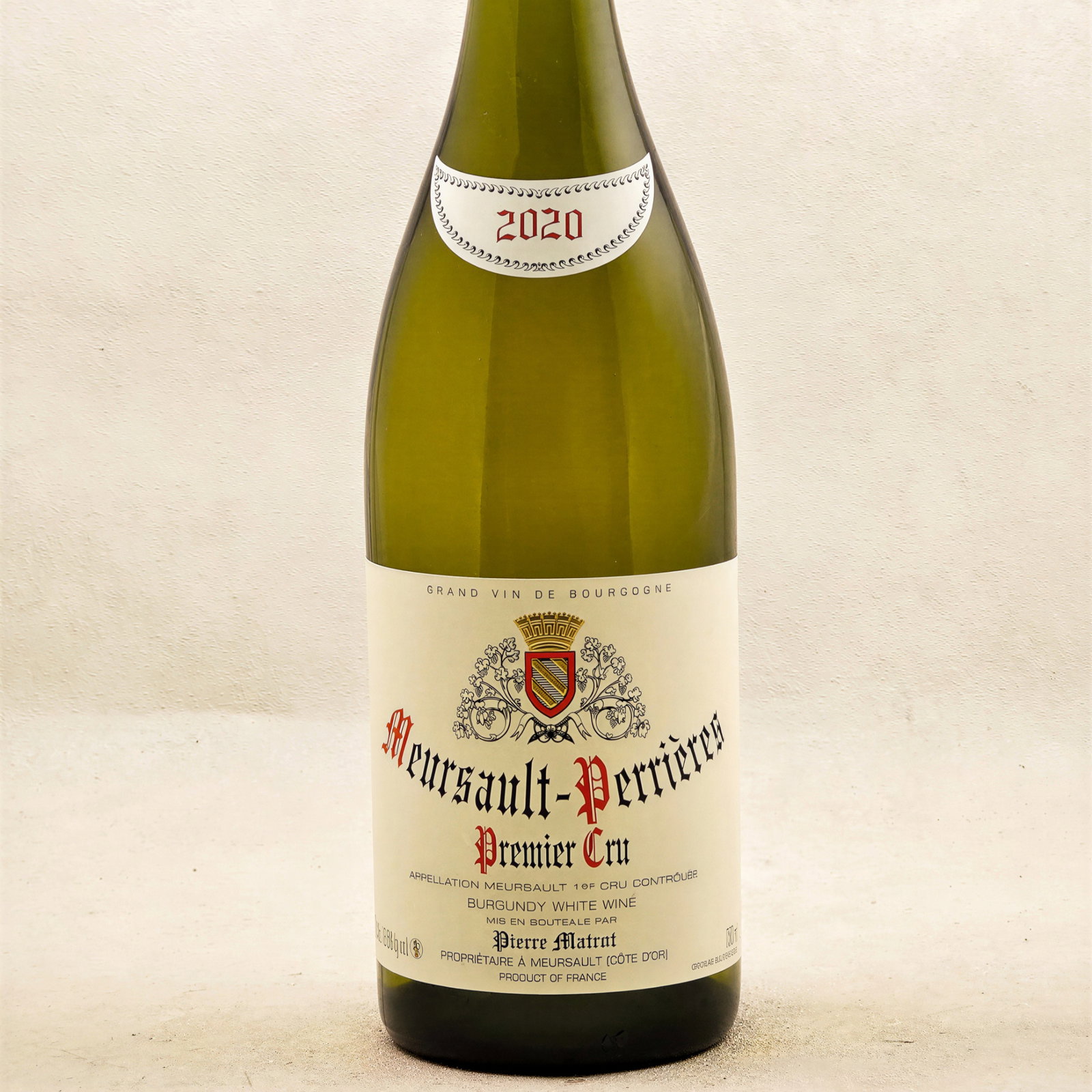 Burgundy wine bottle, labeled Meursault-Perrières Premier Cru 2020, against a light textured background. Elegant, classic design.