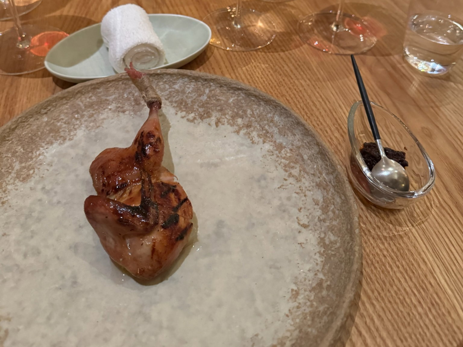Lacquered and Smoked Quail with a condiment of innards, broth of grilled bones
