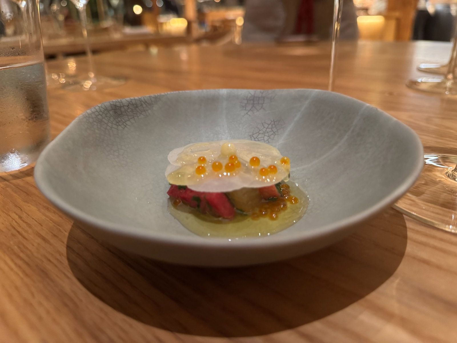 A Raw Preparation of Halibut with seaweeds and bone vinegar, radishes, butter, and smoked trout roe