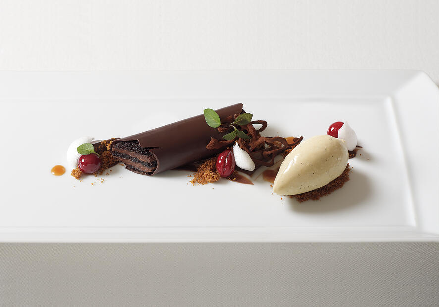 A chocolate covered chocolate bar, vanilla bean ice cream and garnishes
