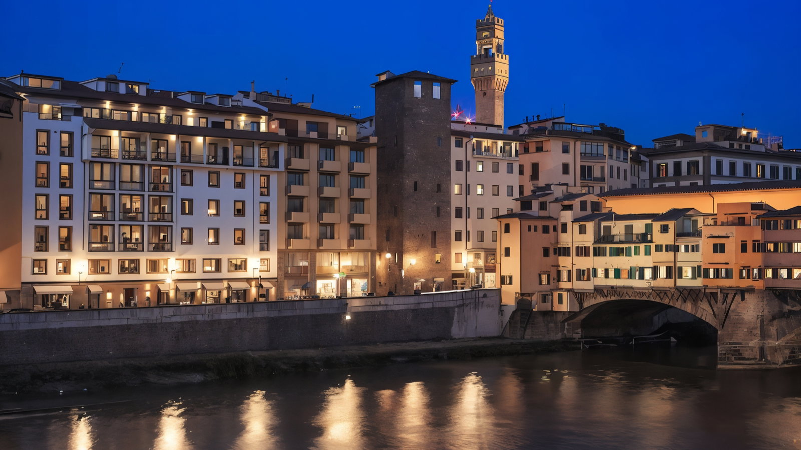 Riverside buildings in Florence glow under a deep blue evening sky. Reflections ripple on water, creating a serene urban scene.