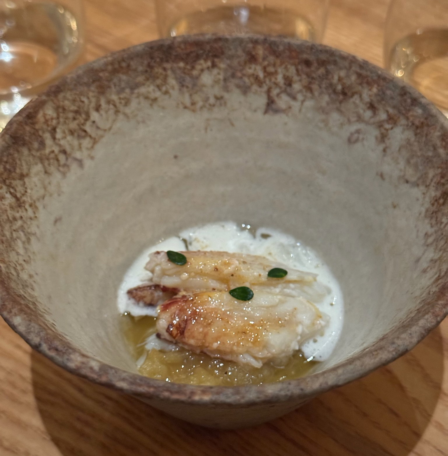 Grilled Red Abalone with a bouillon of its trimmings, pig face, and local lettuces