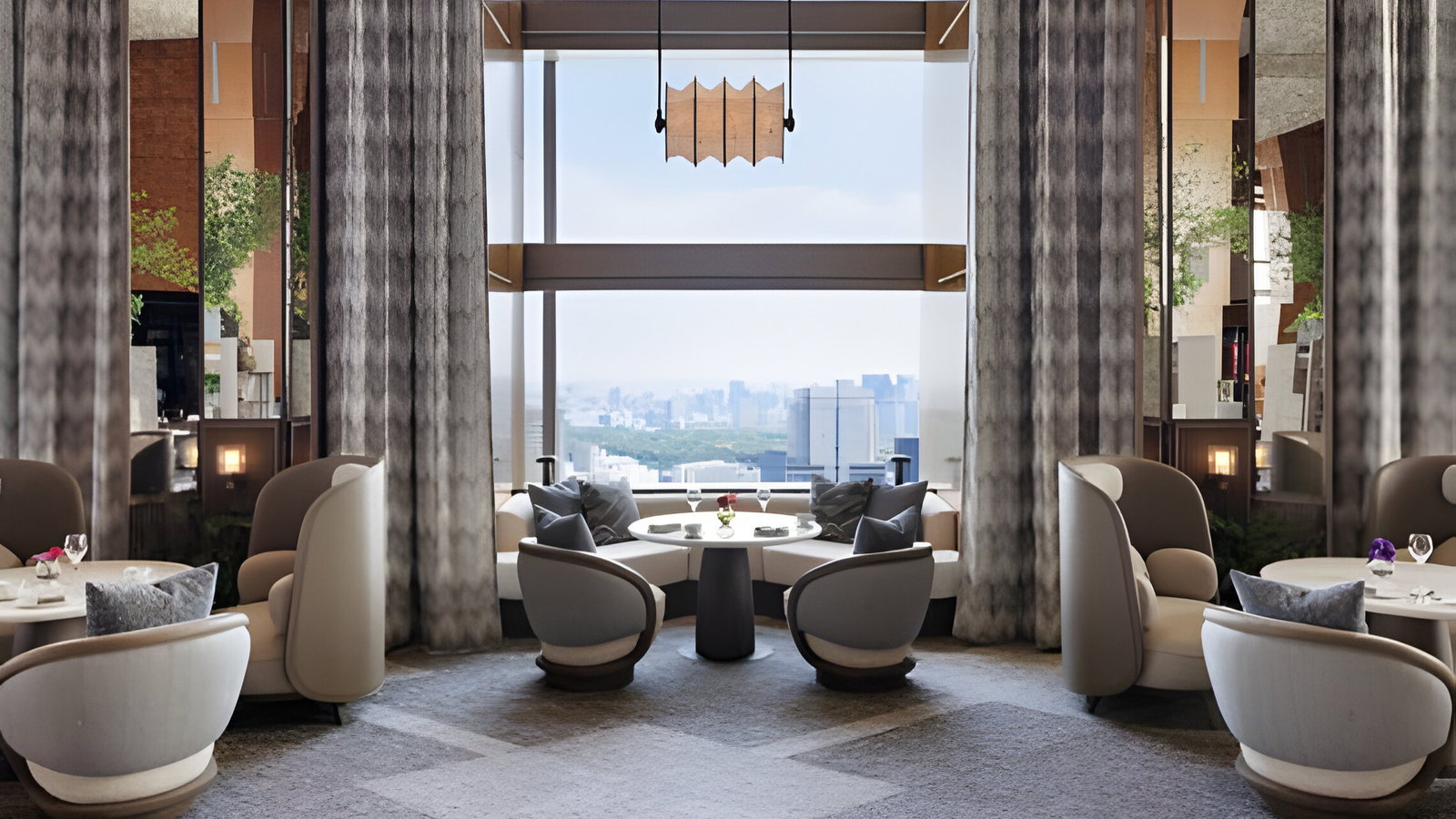Luxurious modern dining room with round tables, cushioned chairs, and large windows overlooking a cityscape. Elegant, serene ambiance.