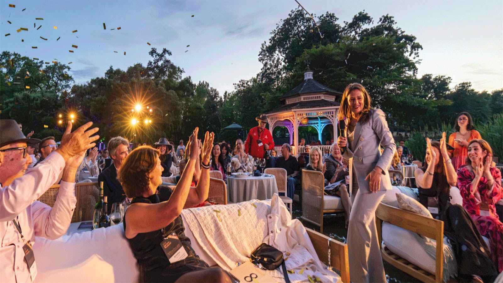 People clapping for an auctioneer or announcer at the Napa Valley Wine Auction