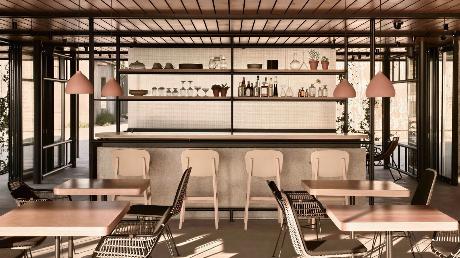 Modern bar at Dexamenes Seaside Hotel interior with wooden tables, black chairs, and a bar. Soft lighting, warm tones, shelves with plants, glasses, and bottles.