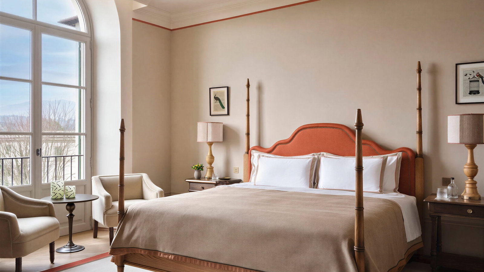 Elegant balcone king bedroom at Collegio alla Querce with a large bed, orange headboard, and beige bedding. Two armchairs by a tall window overlooking trees. Warm, cozy feel.