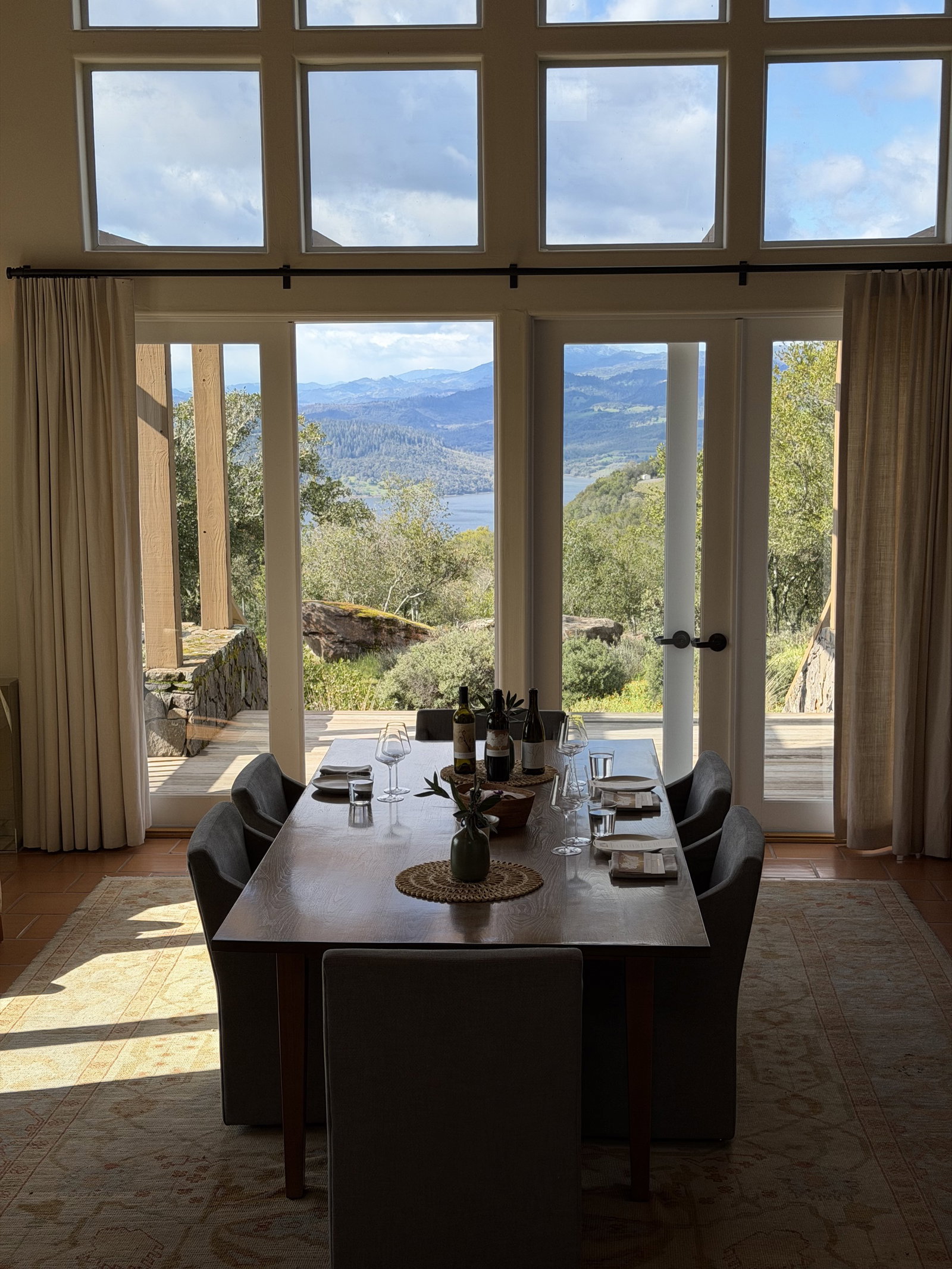 Continuum Estate tasting table inside a house with large doors opening toward the mountain view