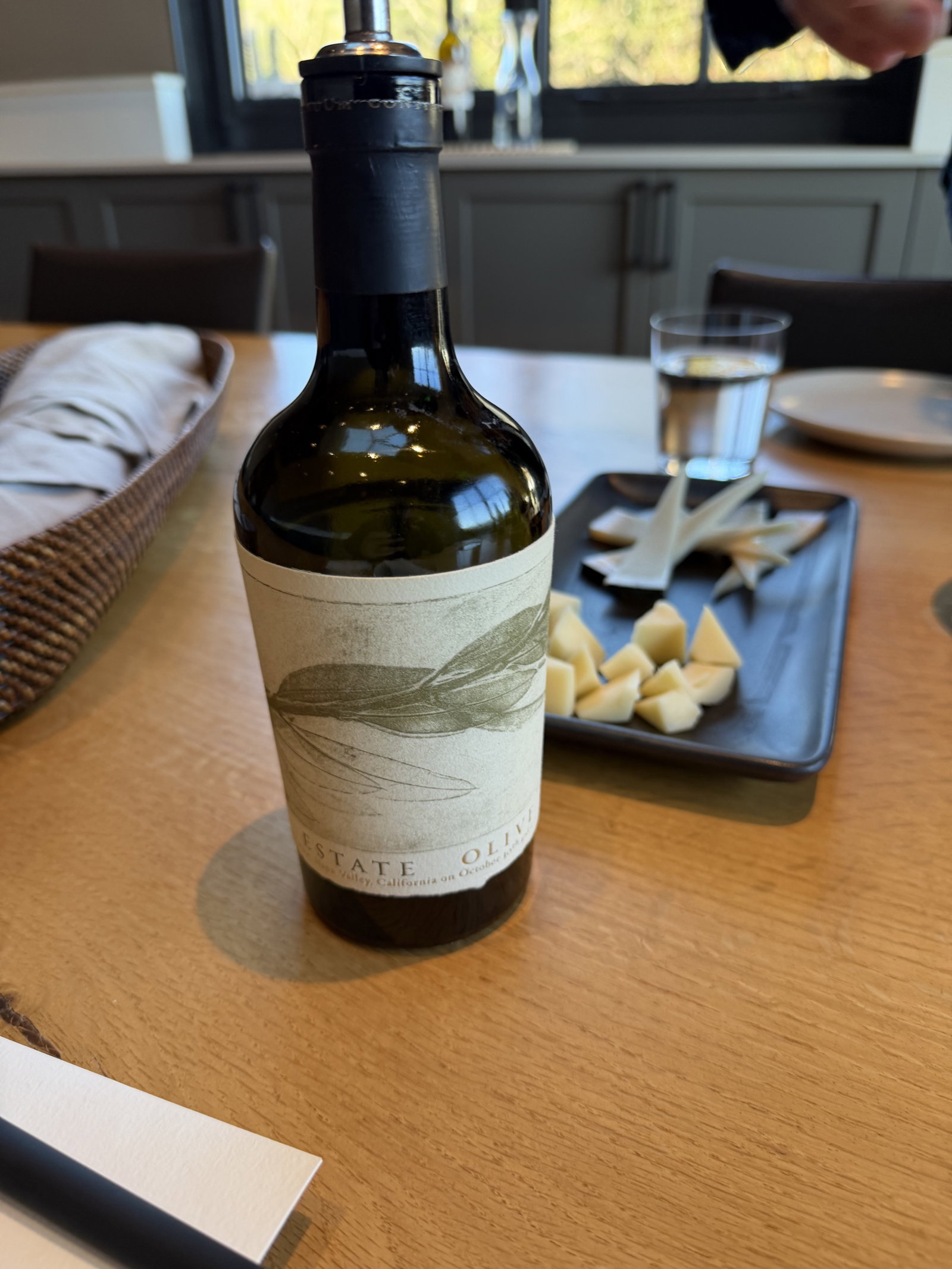 Continuum Estate olive oil bottle with cheeses and tasting bites
