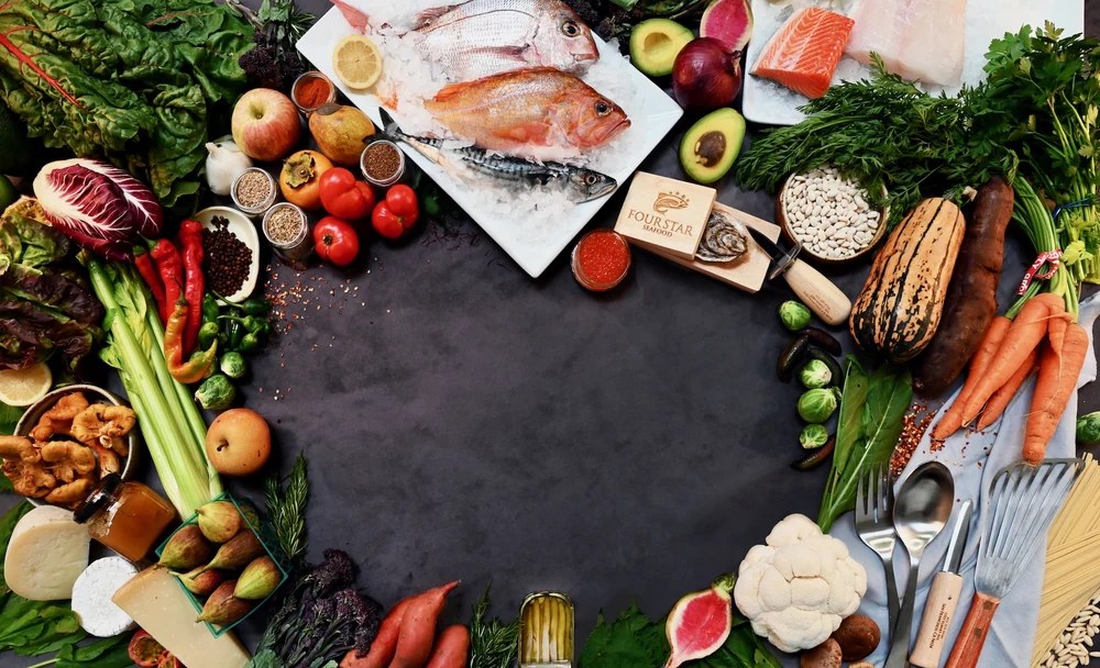produce, pasta, seafood on ice, exotic cheeses, beautiful italian honeys, anchovies in a tin, greens galore that make you think this place has got it all when it comes to culinary offerings. these are arranged with an opening in the center to display our logo Four Star Seafood an